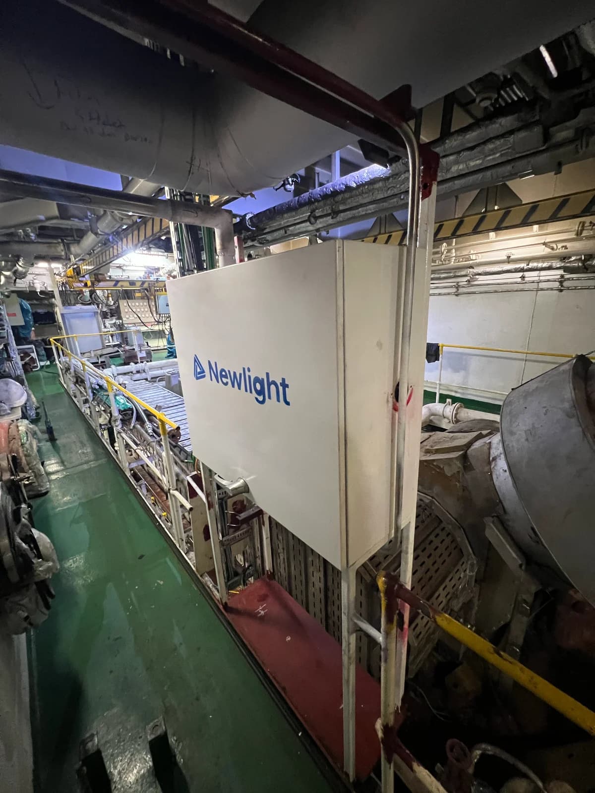 White Newlight cabinet mounted beside a walkway in the vessel engine room