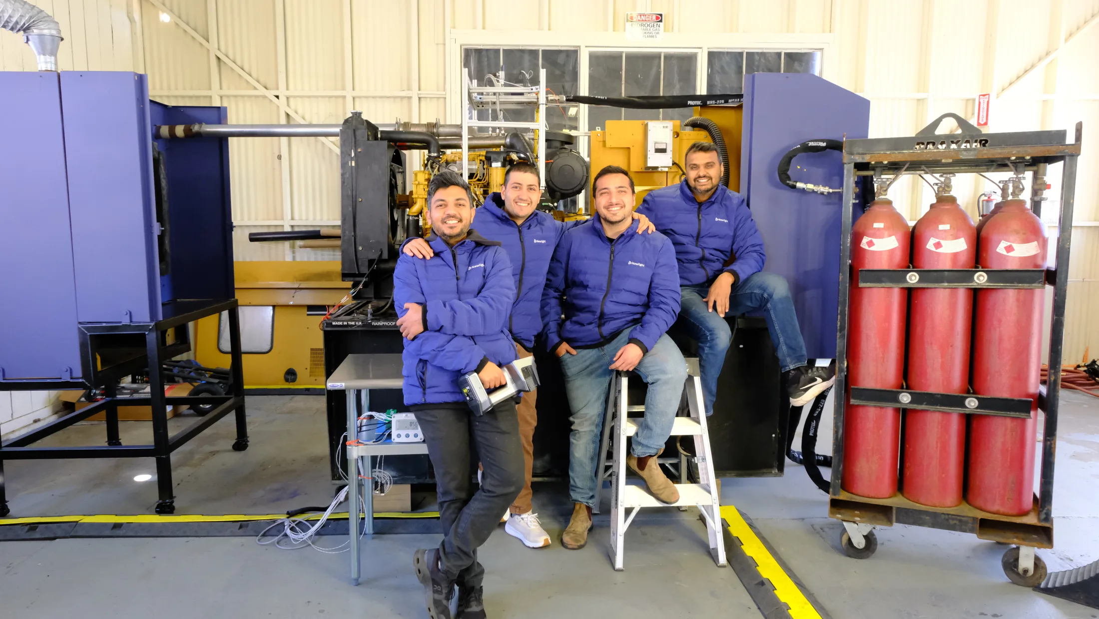Newlight engineers beside the company’s hydrogen-diesel test system