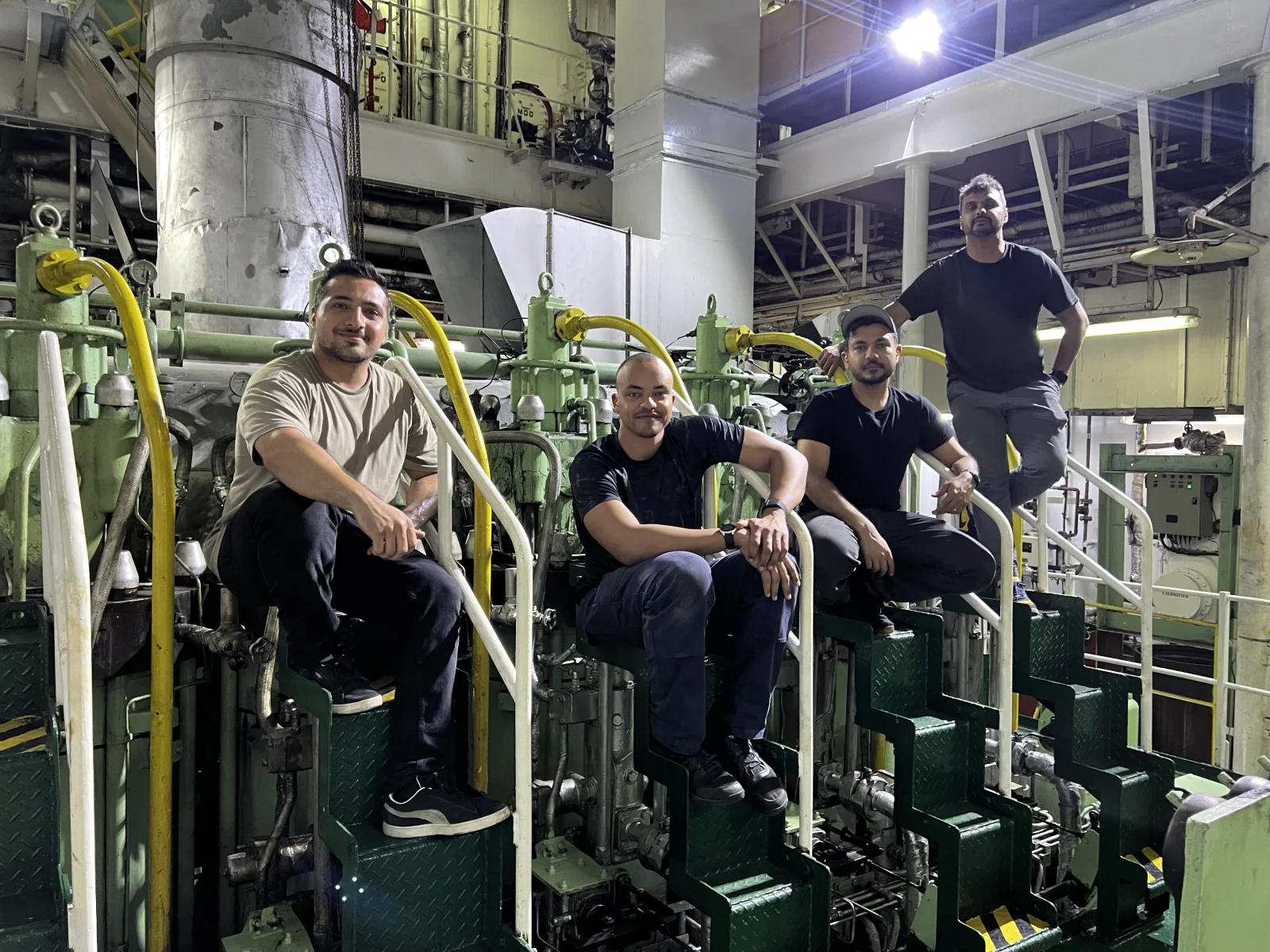 Newlight team working beside a marine engine